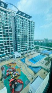 an aerial view of a water park in front of a large building at Vista Alam Roomstay Homestay in Shah Alam