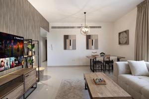 a living room with a couch and a table at 2BHK Al Zahia Apartment, Sharjah - Boho Nest in Sharjah