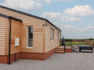a tiny house with a deck and a patio at Waverley Cottage in Hull