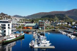 a group of boats are docked in a harbor at Quality Hotel Ulstein in Ulsteinvik