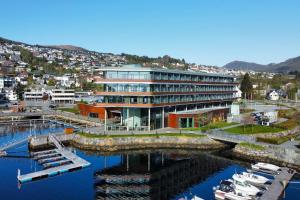 un edificio con puerto deportivo con barcos en el agua en Quality Hotel Ulstein en Ulsteinvik