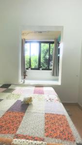 een kamer met een raam en een tapijt op de vloer bij Lee Homestay in Hanoi