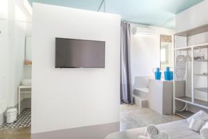 a living room with a tv on a wall at Fico! Apartments by MONHOLIDAY in Monopoli