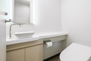 a bathroom with a white sink and a toilet at Grand Phenix Hakuba by Jade Villa in Hakuba +152 photos