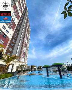 a swimming pool in front of a building at CupidWood Residensi Ostia Bangi with Pool free NEFLIX, Wifi, Parking in Bandar Baru Bangi