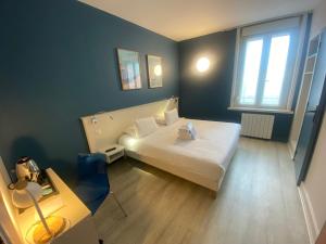 a small room with a white bed and a window at H&ocirc;tel De Wimereux in Wimereux