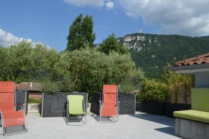 a group of chairs sitting on top of a patio at Maison chez nous in Izeron