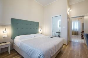 a bedroom with a large bed with a large headboard at B&B aMare - Il Battito del Mare a due passi in Giulianova