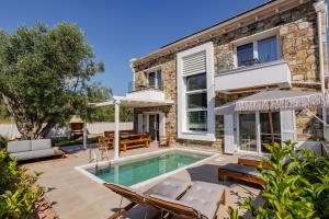 a villa with a swimming pool and a house at Petritis Villas in Iraklitsa