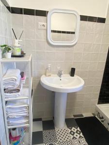 a bathroom with a sink and a mirror and towels at MarePorto House in Fiumicino +17 photos