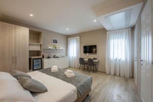 a bedroom with a large bed and a dining room at Villa Carducci in Comacchio