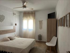 a bedroom with a bed and a ceiling fan at Masia Bernat in Tortosa