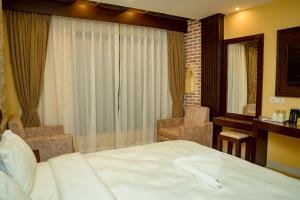 Postel nebo postele na pokoji v ubytování Hotel Matina Suites