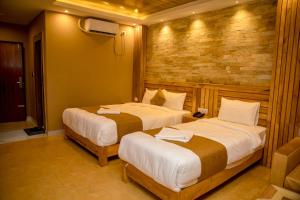 Postel nebo postele na pokoji v ubytování Hotel Matina Suites