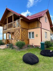 a house with two bean bags in the yard at Ela’s retreat in Dealu Mare