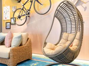 a room with two swing chairs and a bike on the wall at Comfort Inn Naha Tomari Port in Naha