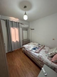 A bed or beds in a room at El Rehab city Cozy apartment 3 bedrooms
