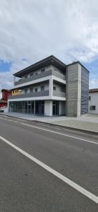 a large building on the side of a road at Dormi-RE Affittacamere in Reggio Emilia +9 photos