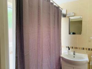 a bathroom with a shower curtain and a sink at Families and contractors Free off road parking in Huntingdon