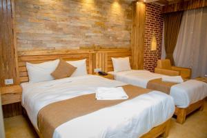 Postel nebo postele na pokoji v ubytování Hotel Matina Suites