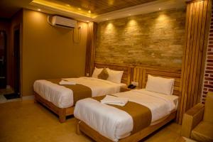 Postel nebo postele na pokoji v ubytování Hotel Matina Suites