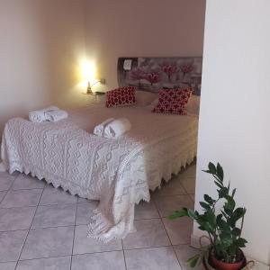 a bedroom with a bed with two pillows on it at B&B Sa Clarera in Baunei
