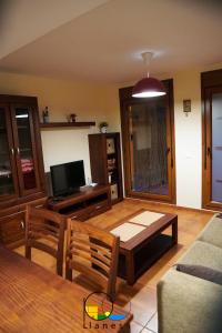 a living room with a couch and a table at Adosado en LLanes in Llanes