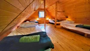 a room with two beds in a wooden cabin at Osada nad Wdą w Borsku in Borsk +67 photos