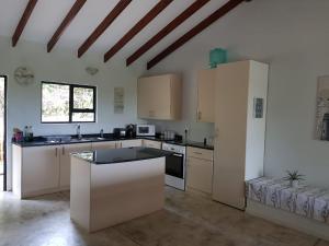 a kitchen with white cabinets and a counter top at Nkumbe 7C in Ponta Malangane