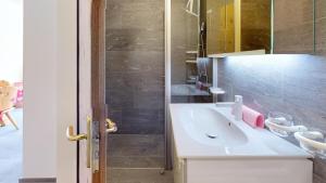 a bathroom with a white sink and a shower at Abitaziun Haus Westend 7A - St Moritz in St. Moritz +6 photos