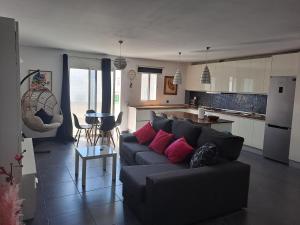 a living room with a couch and a kitchen at Bright in Agaete