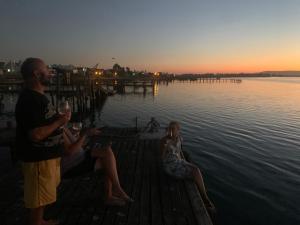 a group of people sitting on a dock near the water at Bergriver Nest in Velddrif +1 photo