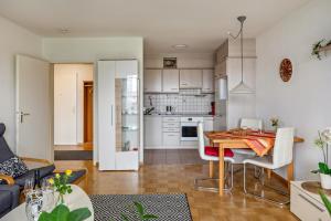 a kitchen and living room with a table and chairs at Meienreis in Breisach am Rhein
