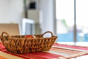 a basket on a table with an apple in it at Meienreis in Breisach am Rhein