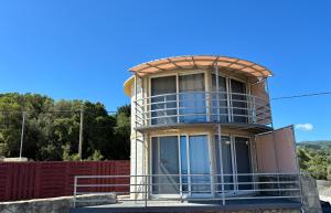a building with a curved roof and a balcony at Silencio Villas in Lefkada