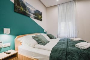 Postel nebo postele na pokoji v ubytování Gál Apartman Szeged -Keco- + 7 fotografií