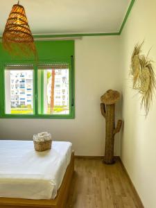 a bedroom with a bed and a window at Luxueux appartement avec vue mer & piscine in Martil +15 photos