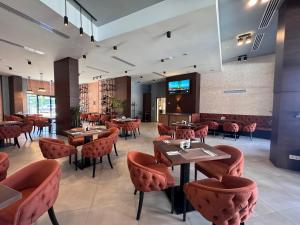 a restaurant with tables and chairs in a room at Prestigio apart Batumi in Batumi