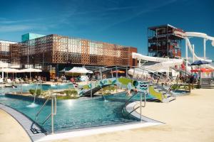 a water park with a slide and a roller coaster at Maison charmante avec jardin in Coutras