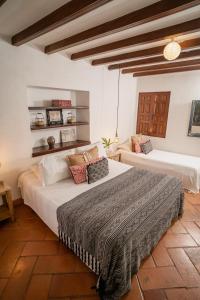 a bedroom with two beds in a room at Hotel Boutique Al Alma in Santa Fe de Antioquia