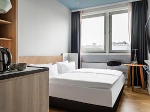 Cama o camas de una habitación en Numa Berlin Kudamm