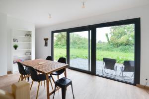 a dining room with a table and chairs at Le D-Day - Sauna - A moins de 2 km de la plage in Sainte-Honorine-des-Pertes