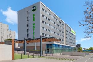 a hotel with a sign on the front of it at B&B HOTEL Barcelona Viladecans in Viladecáns