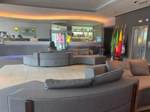 a lobby with couches and a bar in a store at Bes Hotel Bergamo Ovest in Mozzo