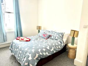 a bedroom with a bed with two pillows on it at Love St Leonards Flat in St. Leonards