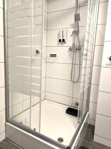 a shower with a glass door in a bathroom at City View in Offenbach +10 photos