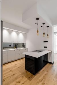 eine weiße Küche mit einer schwarzen Insel in der Mitte in der Unterkunft GuestReady -Marvelous Retreat near Plaza de España in Madrid