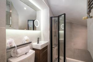 uma casa de banho com um WC, um lavatório e um chuveiro em GuestReady - Fantastic Apt near Regent's Park em Londres