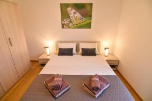 sypialnia z łóżkiem i dwoma ręcznikami na nim w obiekcie Luxury apartment Grotta with sea view and swimming pool w mieście Premantura +21 zdjęć
