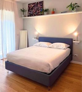 a bedroom with a bed with a blue headboard at Baldo Design Apartment - Rome - MA - Vatican in Rome